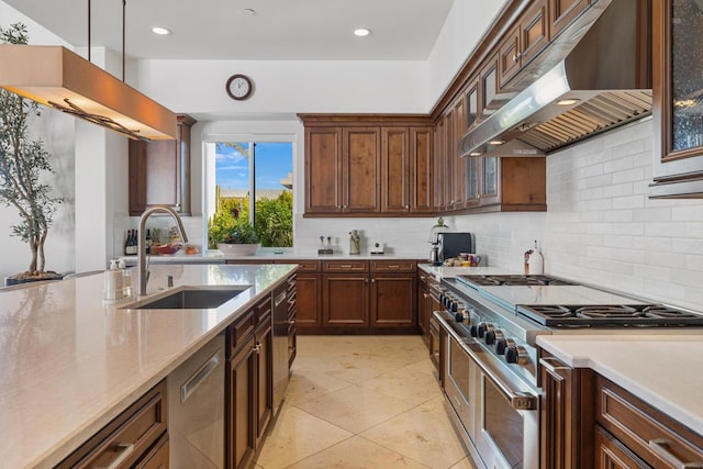 kitchen featuring pendant lighting, sink, appliances with stainless steel finishes, decorative backsplash, and exhaust hood