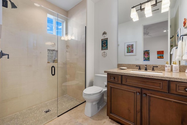 bathroom featuring vanity, toilet, ceiling fan, and walk in shower