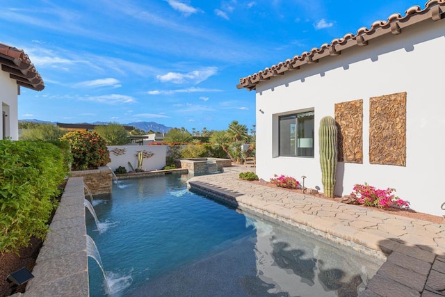 view of swimming pool with an in ground hot tub and pool water feature