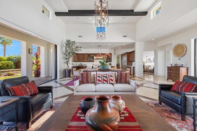 living room with an inviting chandelier and beamed ceiling