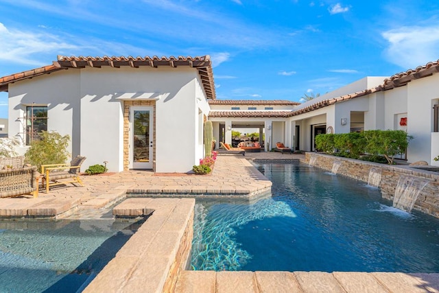 back of house featuring a patio and pool water feature