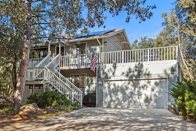 view of front of home with a garage and solar panels