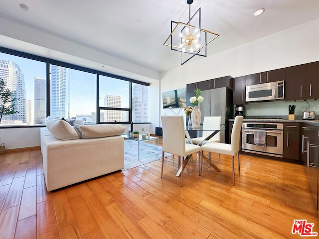 living room with light hardwood / wood-style floors and a chandelier