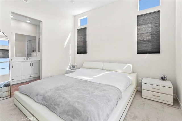 bedroom with sink, multiple windows, and ensuite bath