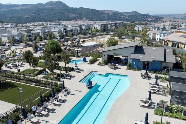 view of swimming pool featuring a mountain view and a patio