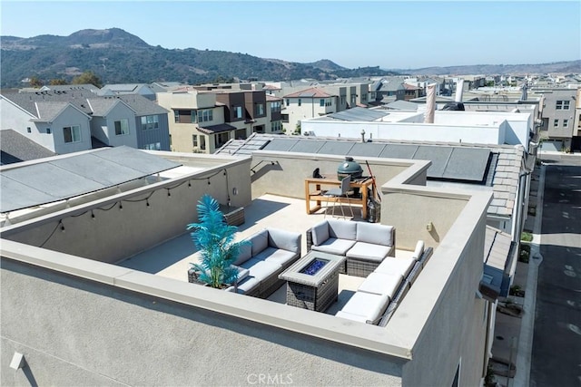 exterior space with a mountain view and an outdoor living space with a fire pit