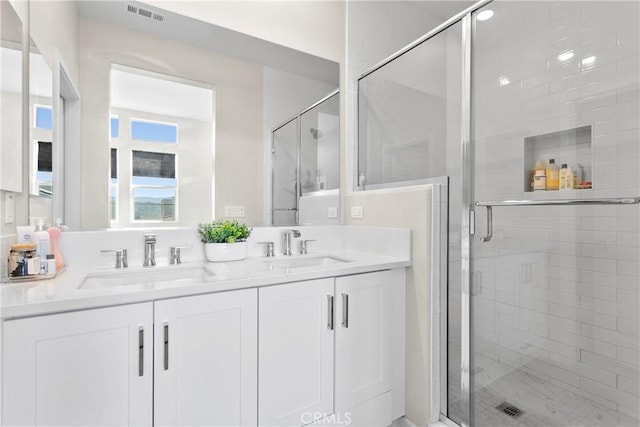 bathroom with walk in shower and vanity