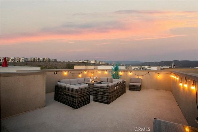 patio terrace at dusk featuring an outdoor hangout area