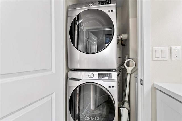 washroom with stacked washer / drying machine