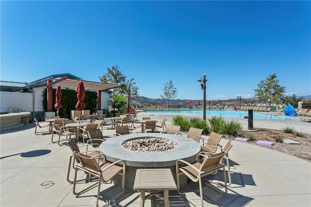 view of patio featuring a community pool and a water view