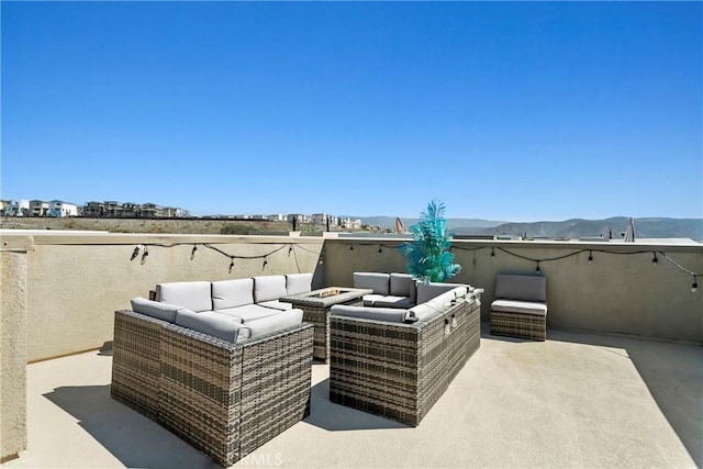 view of patio with outdoor lounge area and a mountain view