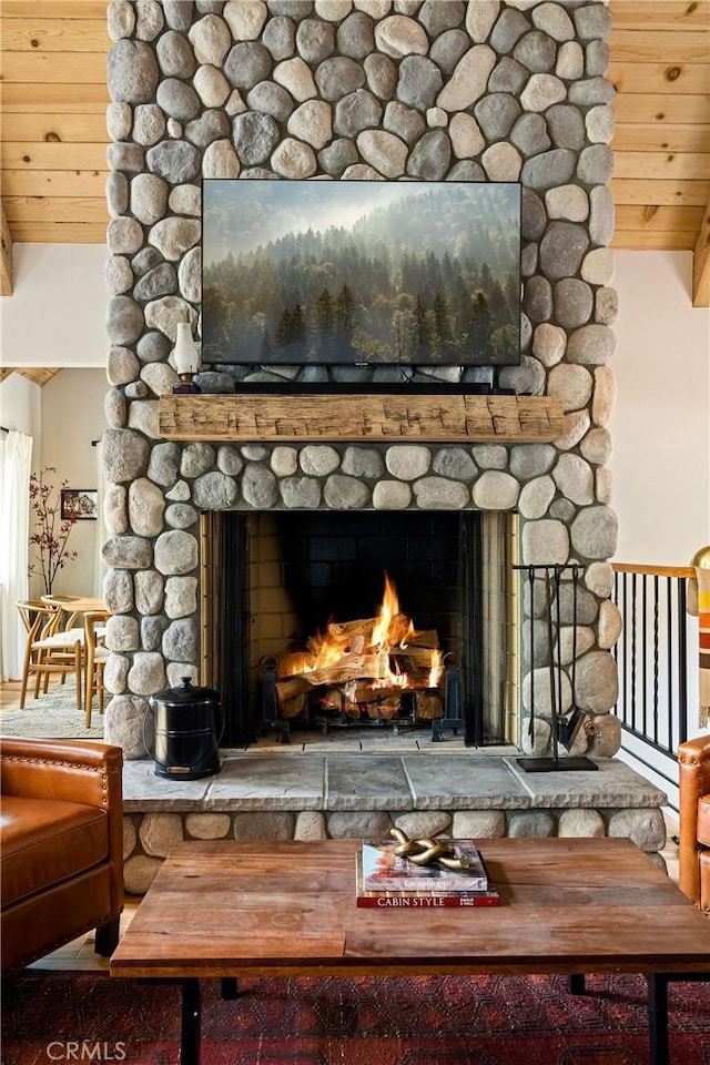 details featuring a stone fireplace and wooden ceiling