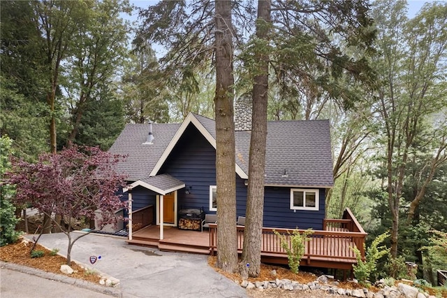 rear view of house featuring a wooden deck