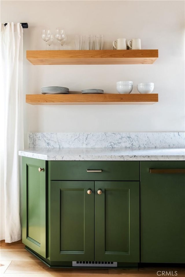 interior space featuring light wood-type flooring and green cabinets