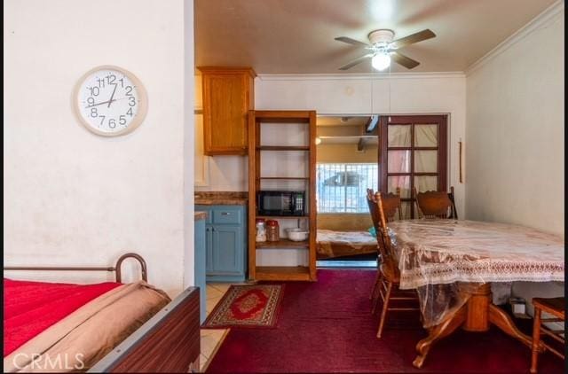 dining room featuring ceiling fan and crown molding