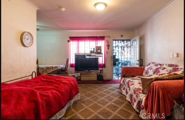 bedroom featuring carpet, a baseboard heating unit, and crown molding