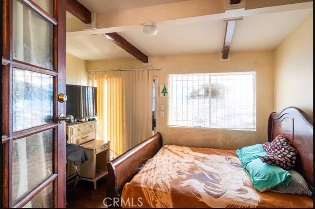 bedroom with beam ceiling