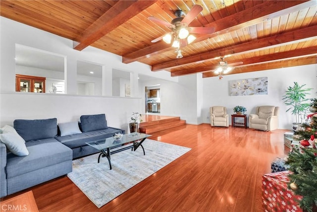 living room with beam ceiling, hardwood / wood-style floors, ceiling fan, and wooden ceiling