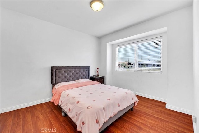 bedroom with wood-type flooring