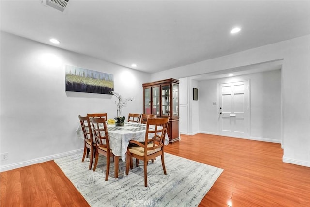 dining space with hardwood / wood-style floors