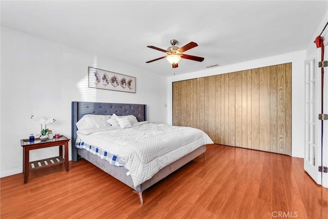 bedroom with ceiling fan and wood-type flooring