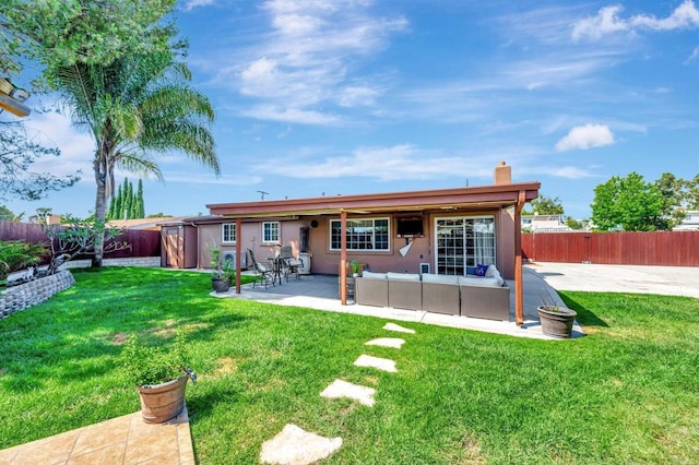 back of property featuring a yard and a patio