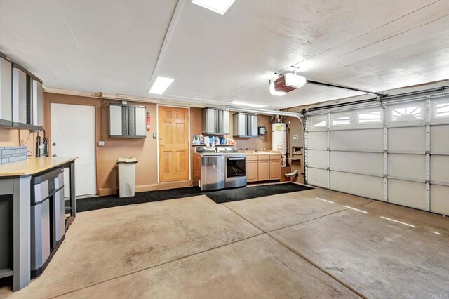 garage with a garage door opener, independent washer and dryer, and gas water heater