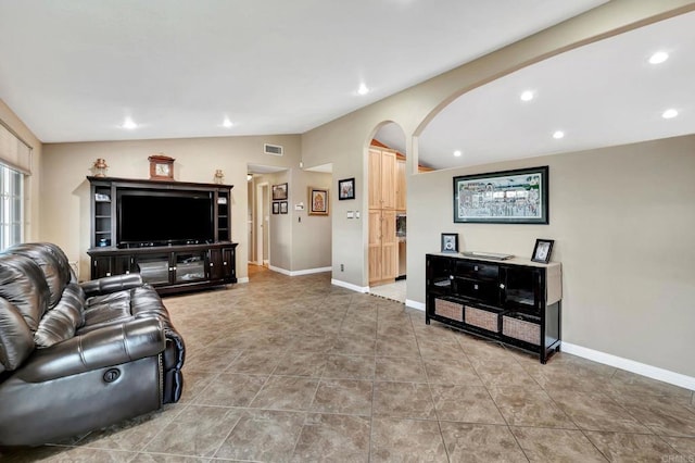 living room with light tile patterned flooring and lofted ceiling