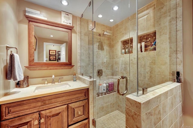 bathroom featuring walk in shower and vanity