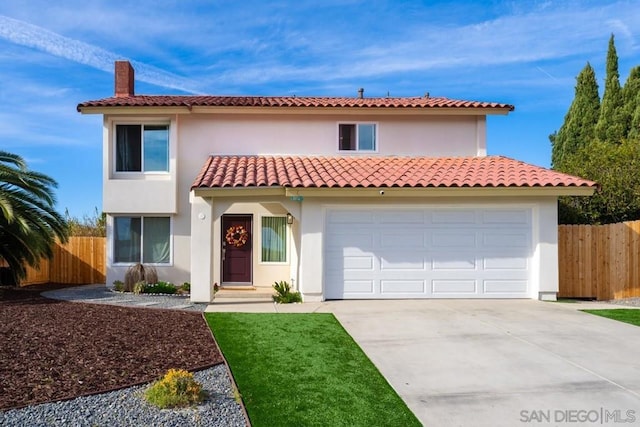 mediterranean / spanish-style house with a garage