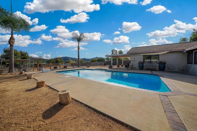 view of pool featuring a mountain view and a patio area