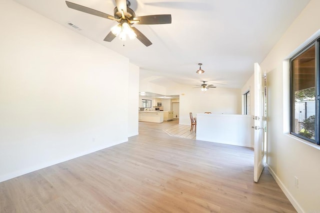 empty room with ceiling fan and light wood-type flooring