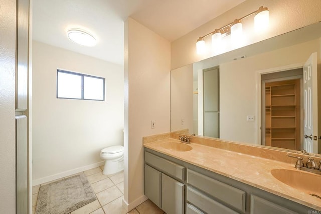 bathroom featuring vanity, tile patterned floors, and toilet