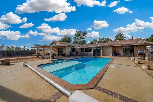 view of pool featuring a grill and a patio area