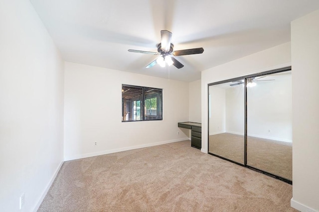 unfurnished bedroom with light colored carpet, ceiling fan, and a closet