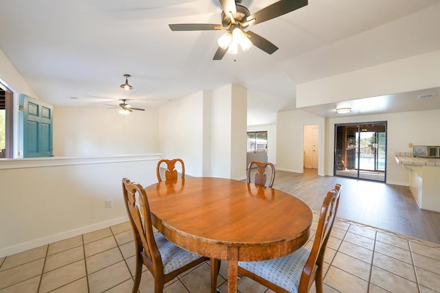 dining space featuring ceiling fan and light tile patterned flooring