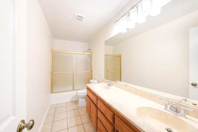 full bathroom featuring toilet, tile patterned floors, shower / bath combination with glass door, and vanity