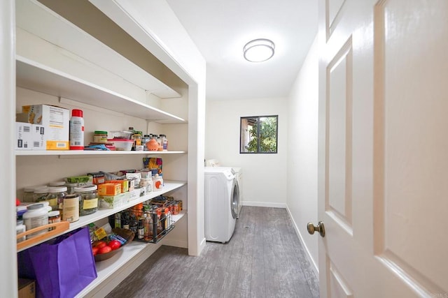 clothes washing area featuring wood-type flooring and washer and clothes dryer