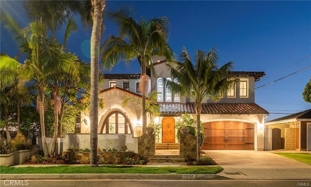 mediterranean / spanish-style house with a garage