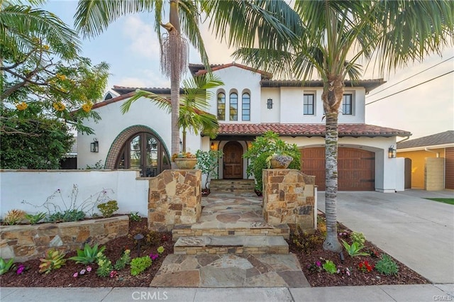 mediterranean / spanish house featuring a garage