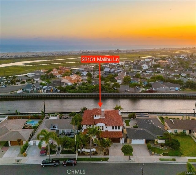 aerial view at dusk with a water view