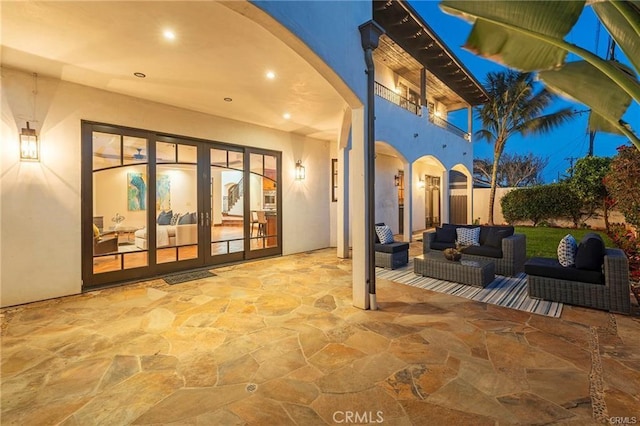 view of patio / terrace with french doors, outdoor lounge area, and a balcony