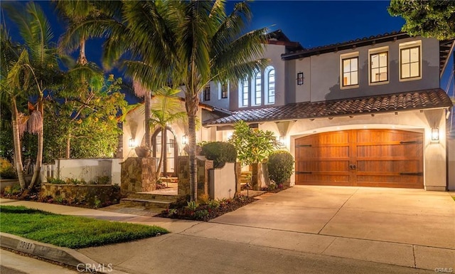 mediterranean / spanish home with a garage