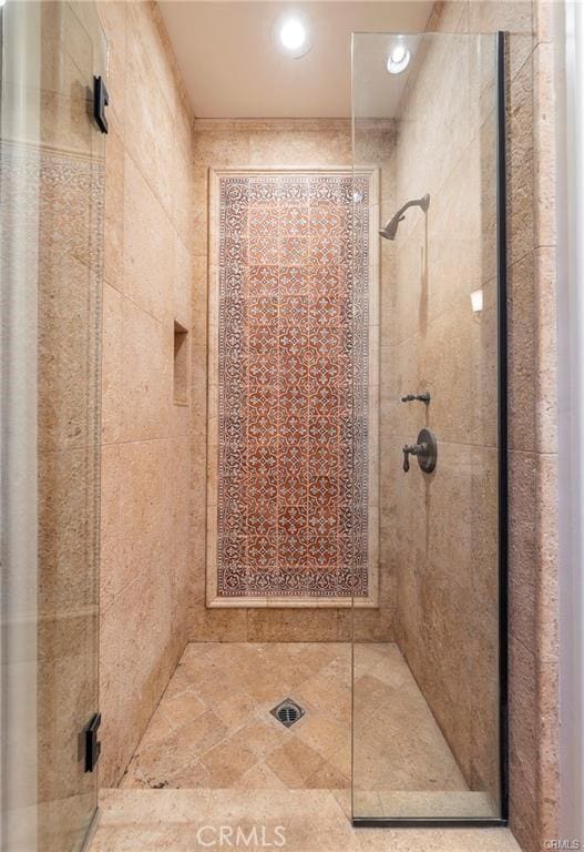 bathroom with a shower with door