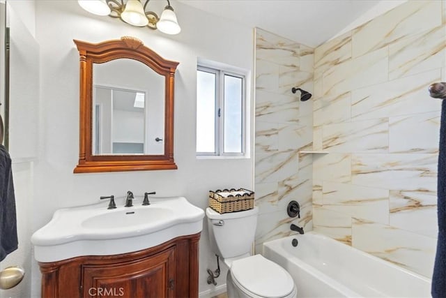 full bathroom featuring toilet, tiled shower / bath combo, and vanity