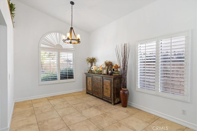 dining space with lofted ceiling, light tile patterned floors, and an inviting chandelier