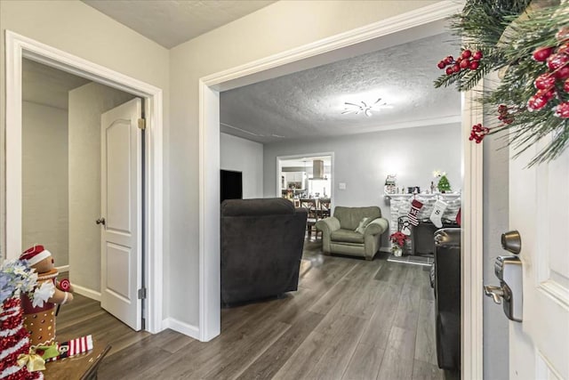 living room with dark hardwood / wood-style flooring and a textured ceiling