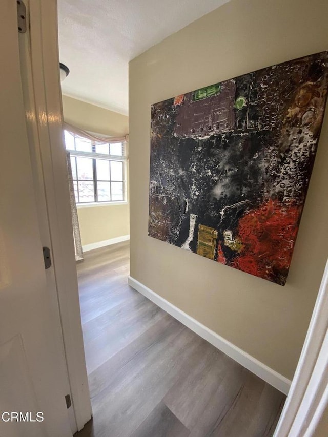 corridor with hardwood / wood-style floors