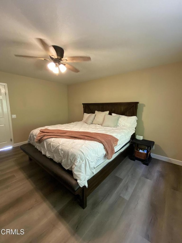 bedroom featuring dark wood-type flooring and ceiling fan