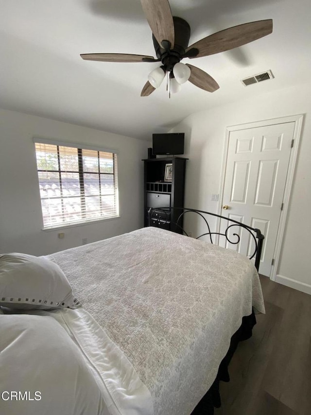 bedroom featuring ceiling fan and dark wood-type flooring